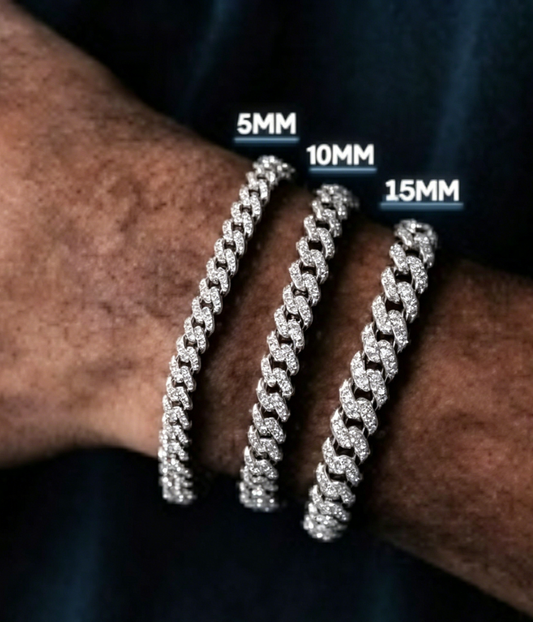 Silver-tone Cuban link bracelets with sparkling stones, three stacked on wrist