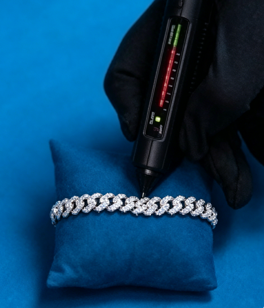 Cuban link bracelet with sparkling stones, displayed on a blue cushion