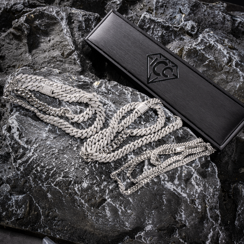 Silver Cuban link chain with diamond-like pavé detail, shown with gift box