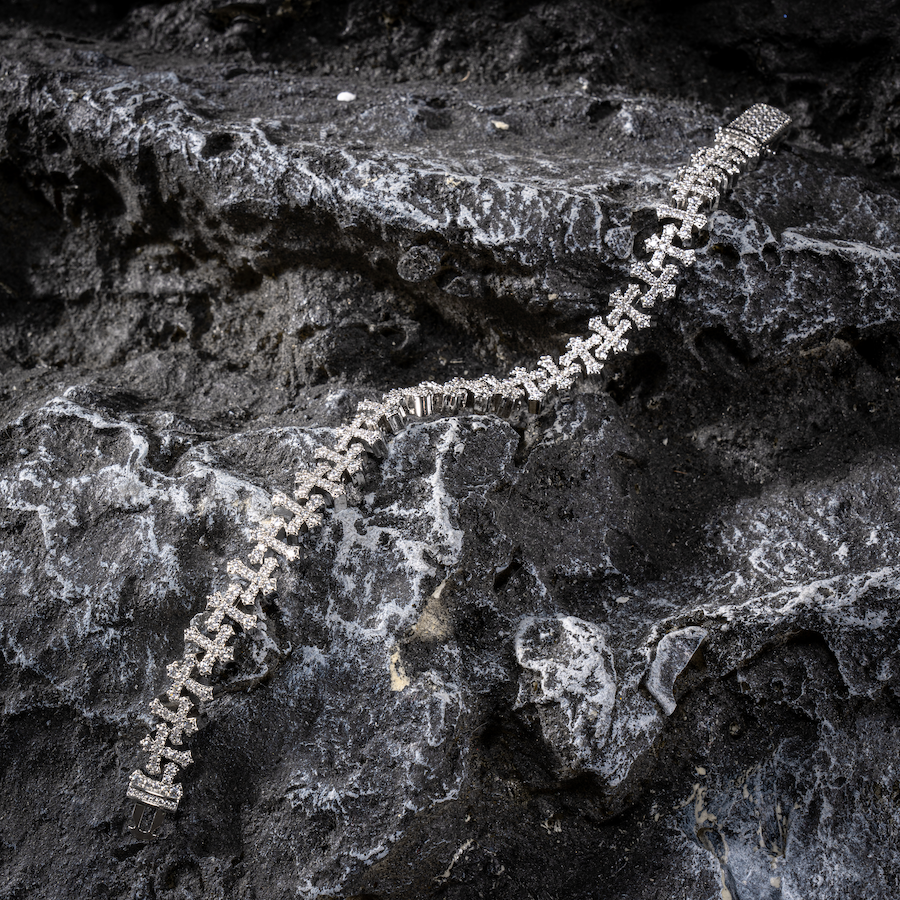 White gold cross-link bracelet with a row of linked cross charms and pavé stones