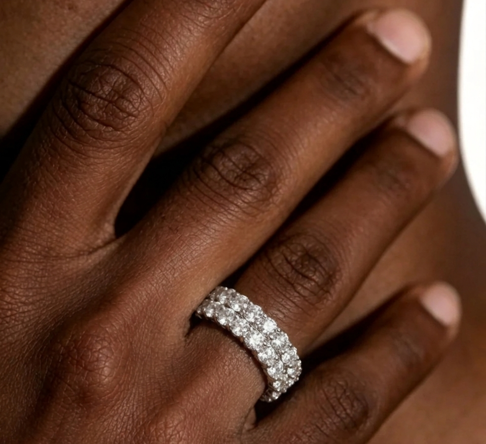 Two-row moissanite band ring on finger, prong-set round stones, silver tone