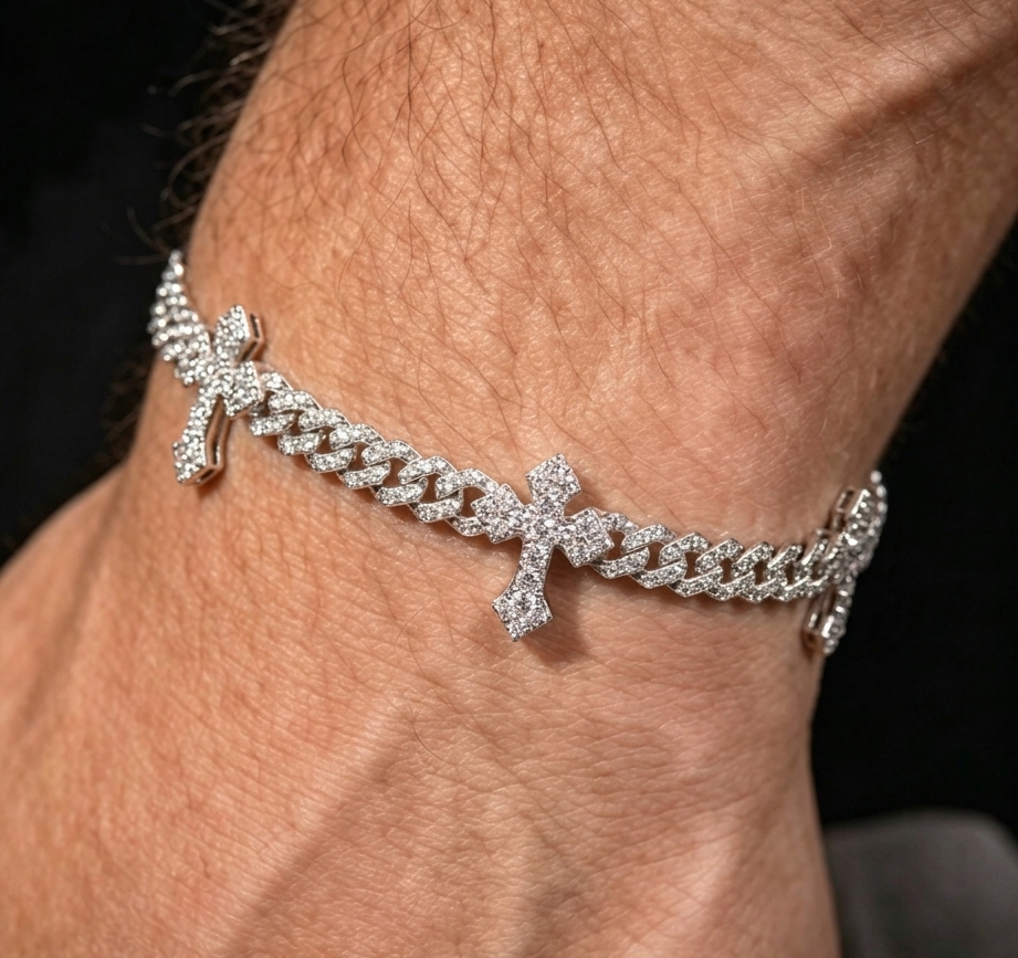 White gold cross Cuban link bracelet worn on wrist with cross charms and sparkling stone links