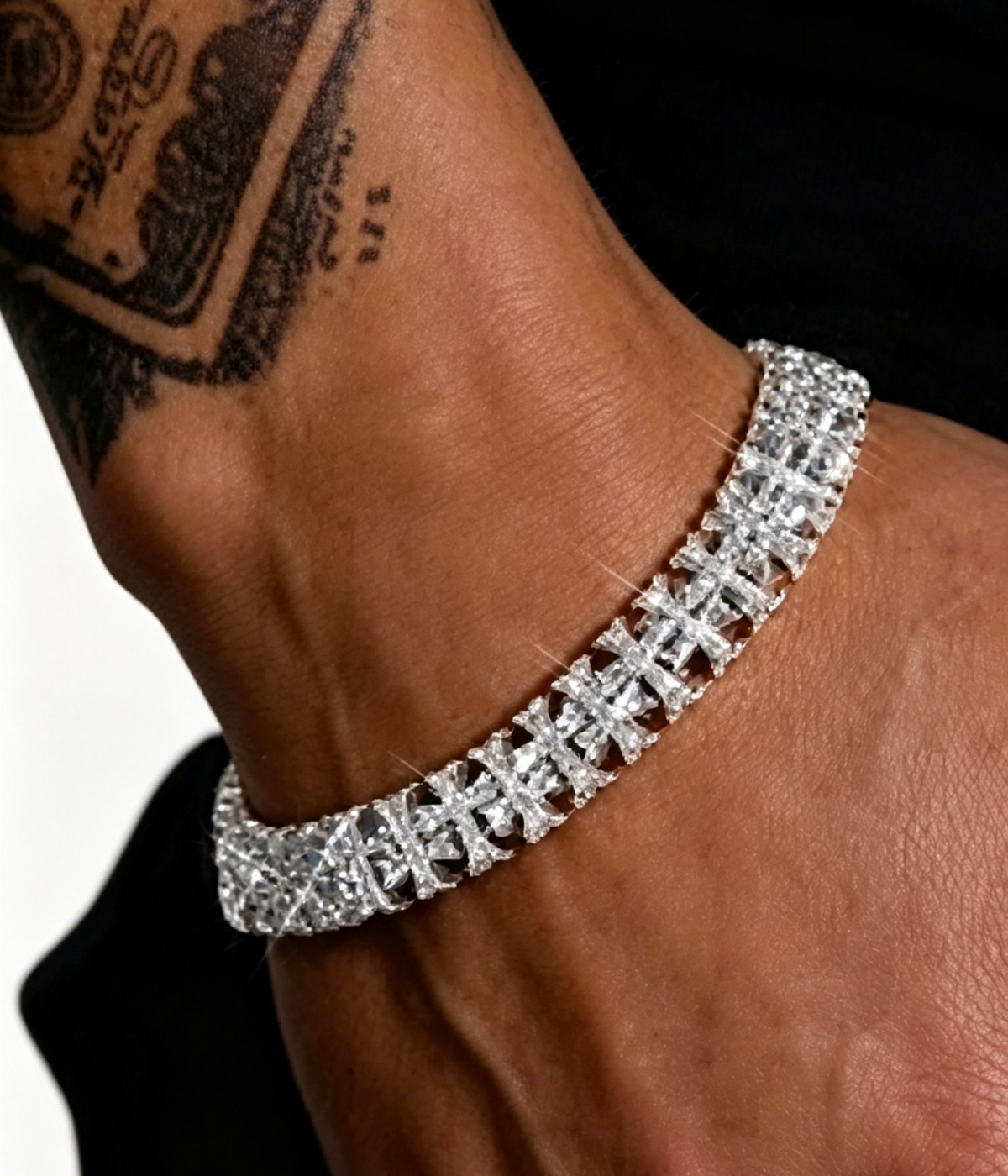 White gold cross-link bracelet on wrist with sparkling cross and rectangular pavé links